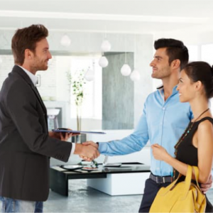 estate agent shaking hands with couple