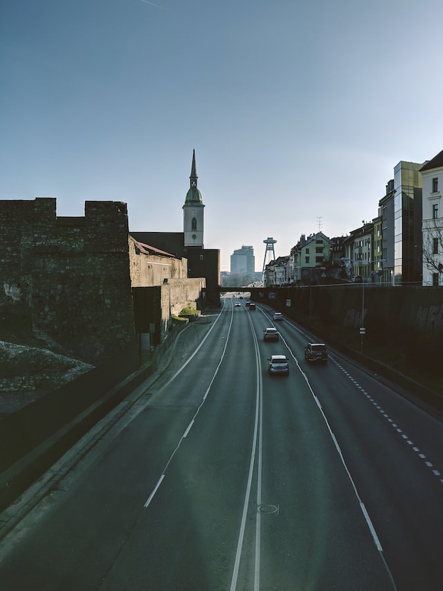 dual carriageway next to buildings and a steeple